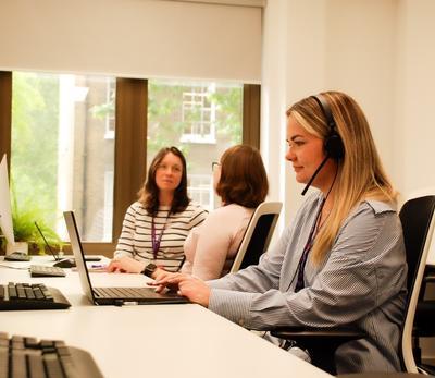 A group of women working at computers__Description automatically generated.jpeg